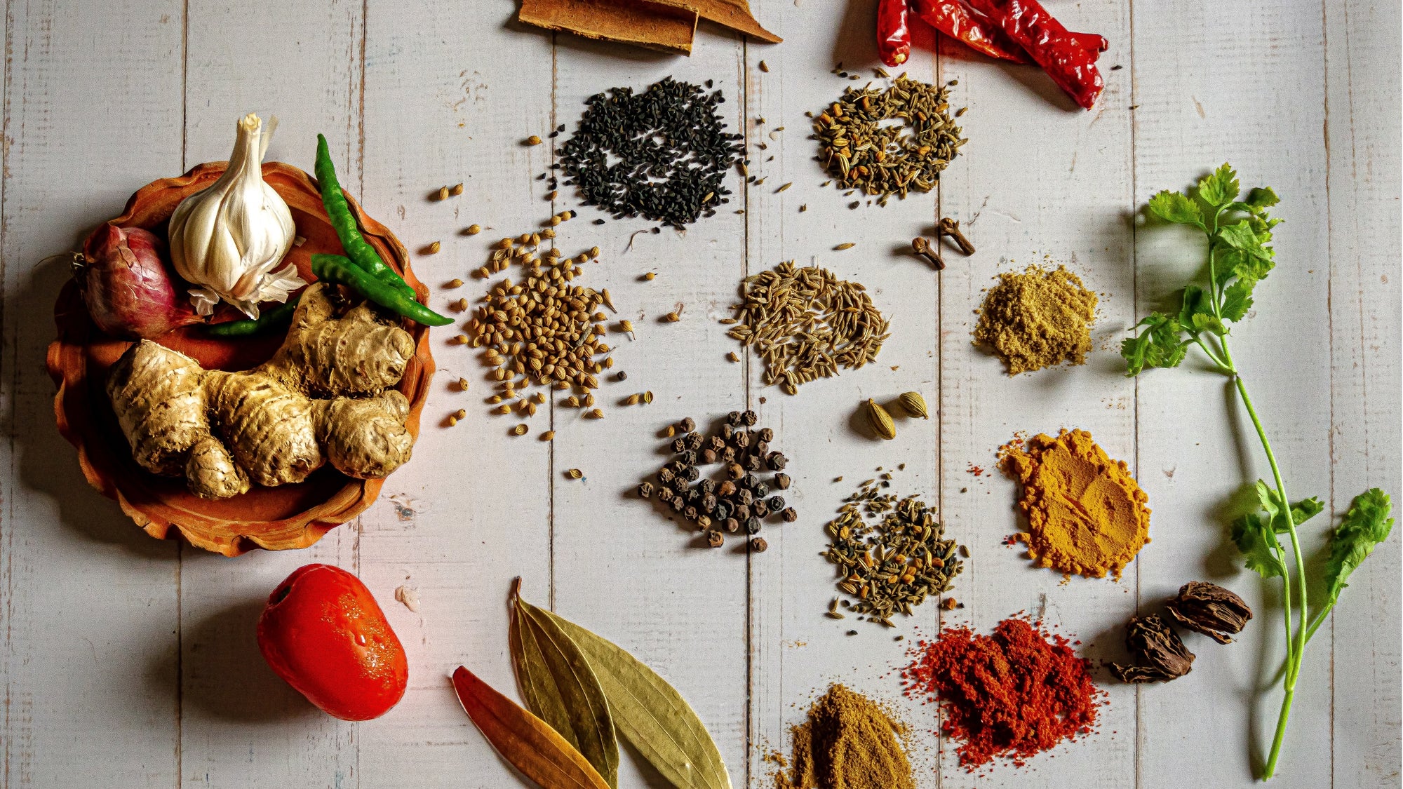 Pepper, ginger and turmeric, spices that reduce inflammation, on a counter in small piles